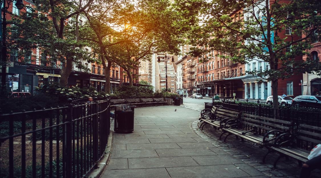 Pathway through city park with benches