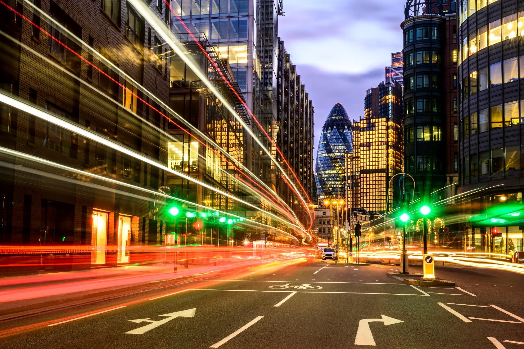 Personal viewpoint of light effects created by buses and cars speeding past camera as commuters travel through City of London financial district.