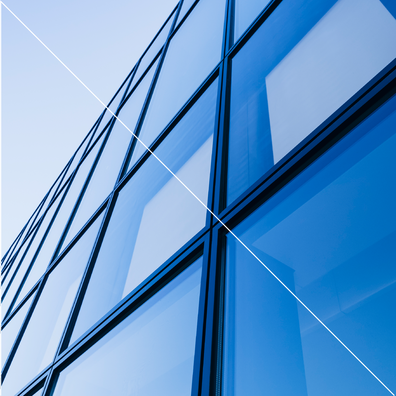Up close of square windows reflecting the blue sky with a right angle white triangle across the image for stylistic impact