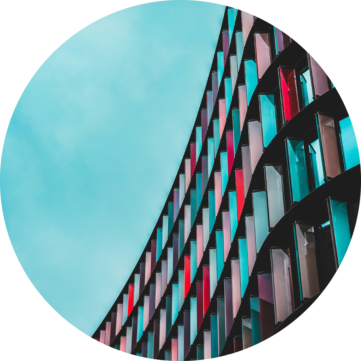 Red and blue geometric windows against a blue sky
