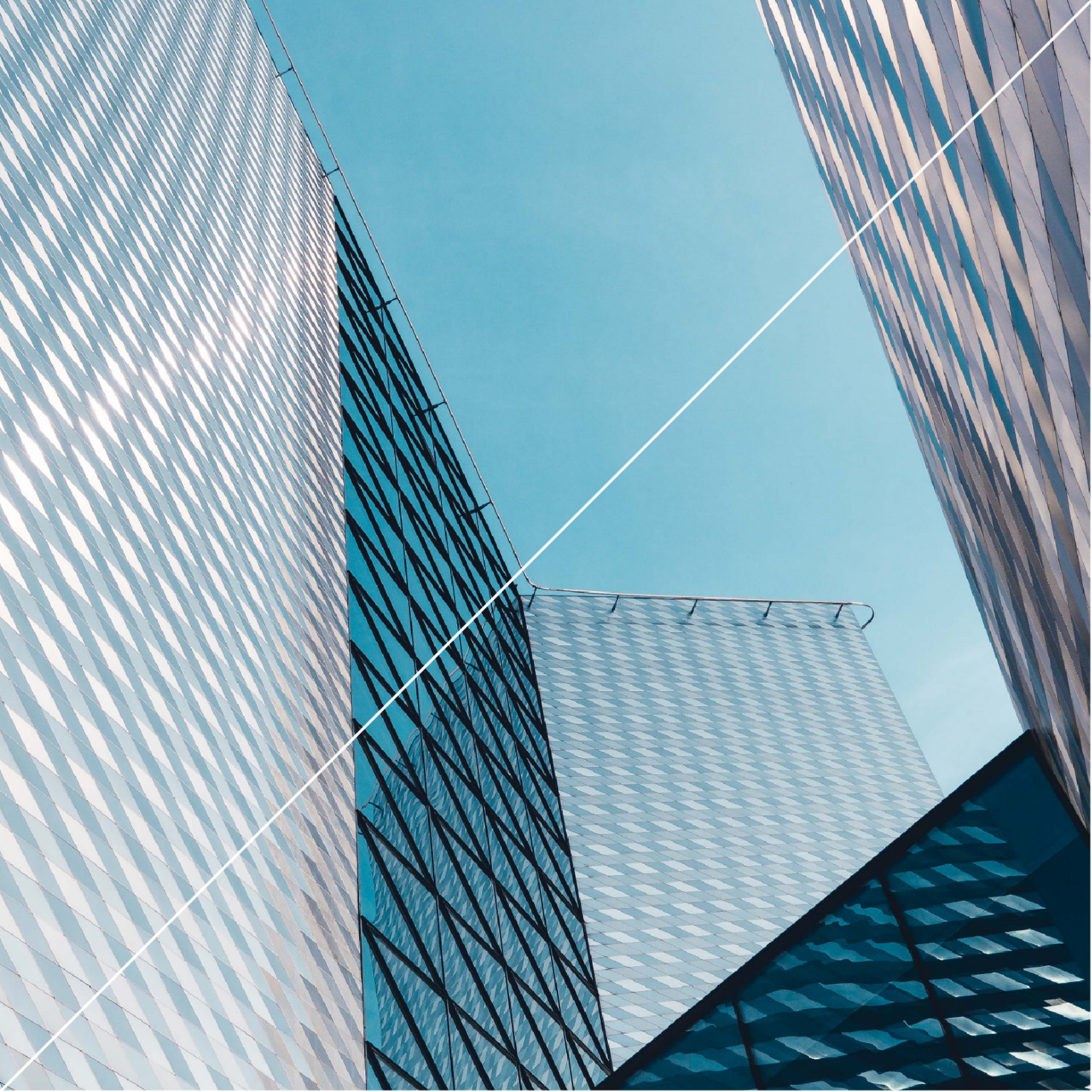 View from the street looking up at a geometric blue skyscraper