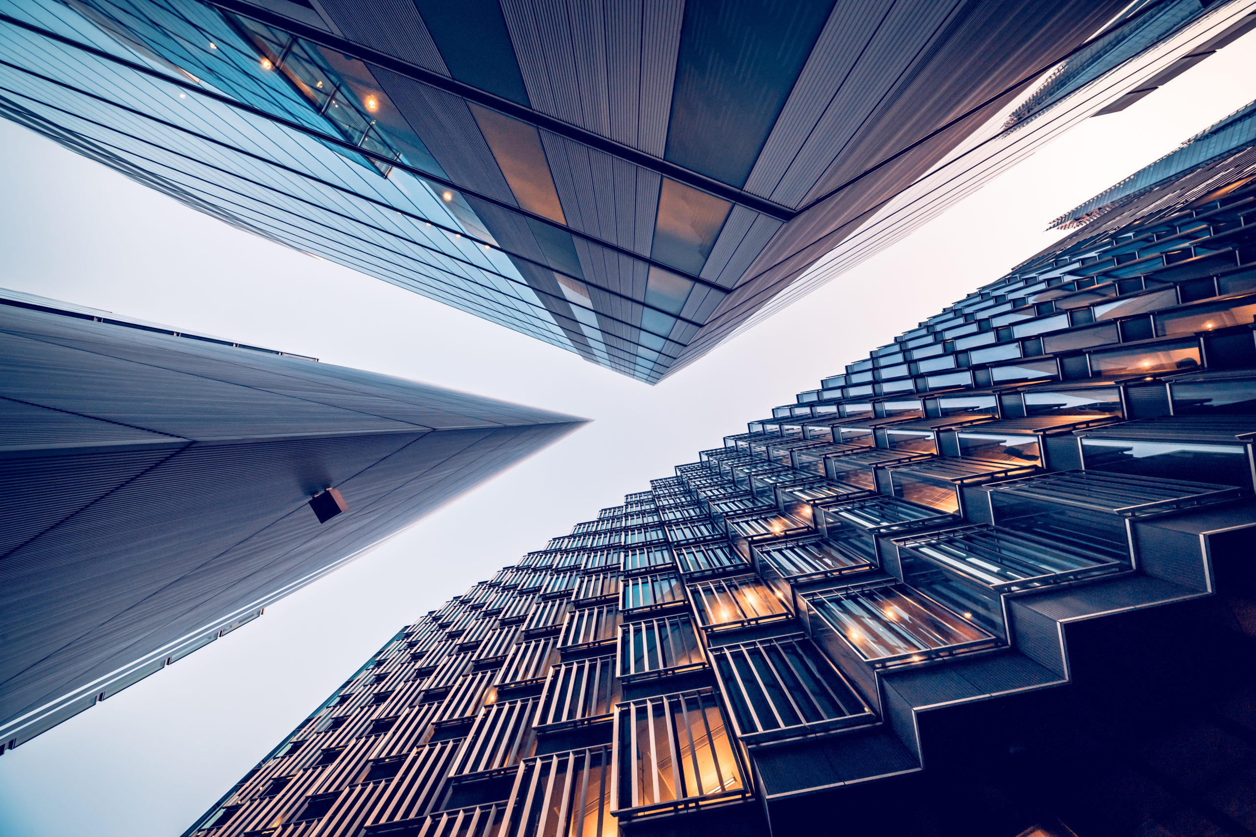 Highly detailed abstract wide angle view up towards the sky in the financial district of London City and its ultra modern contemporary buildings with unique architecture. Shot on Canon EOS R full frame with 10mm wide angle lens. Image is ideal for background. Toned image.