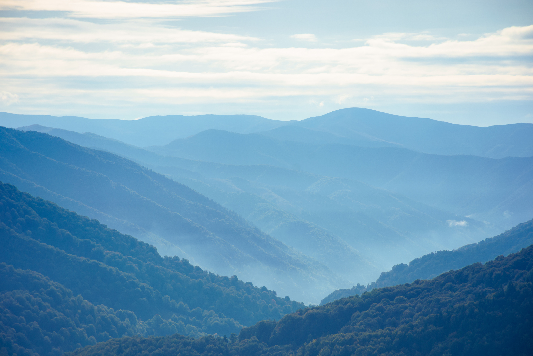 mountain landscape on a summer day. hills rolling from the valley up in to the distant ridge. view of the wonderful outdoor scenery beneath a sky with clouds