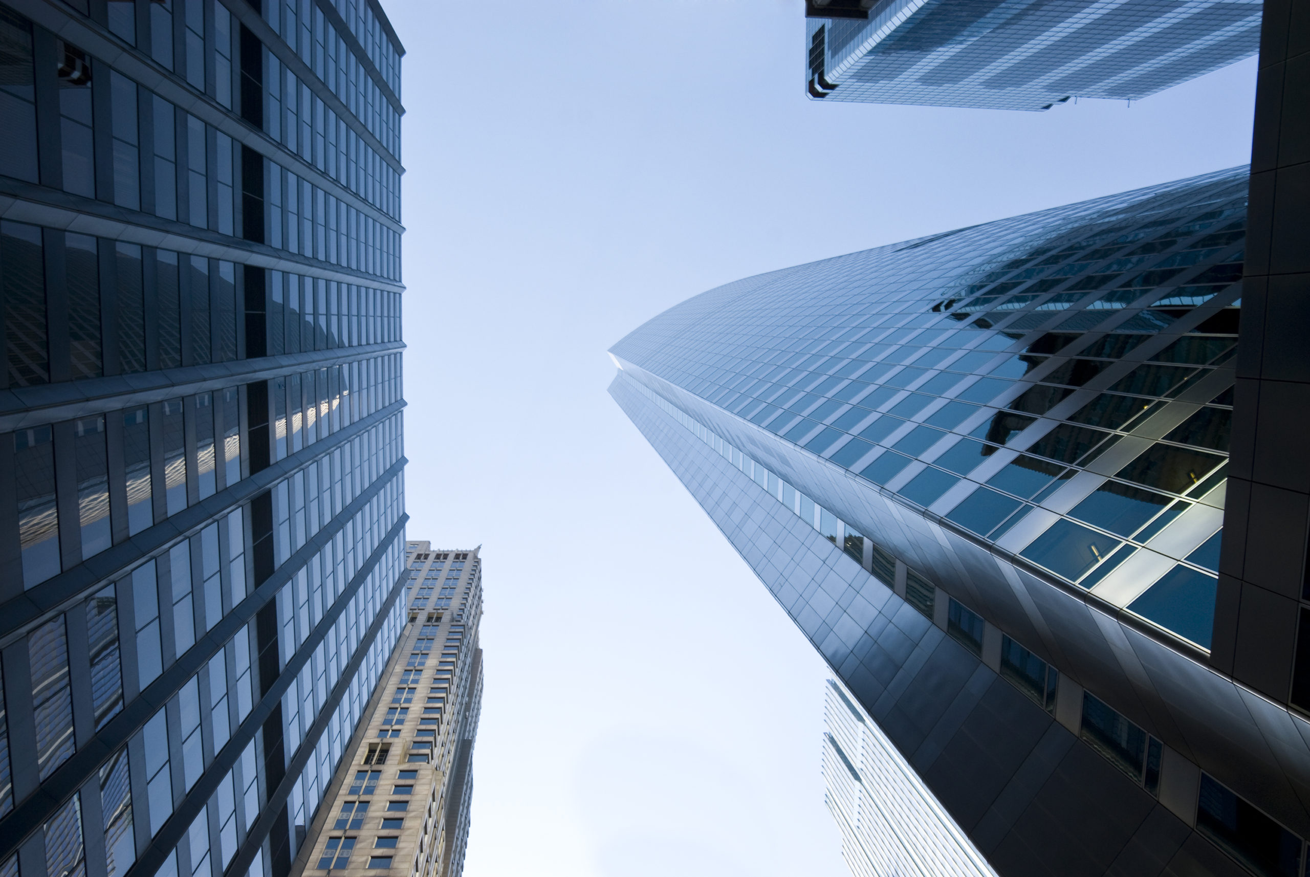 View looking up between three city buildings