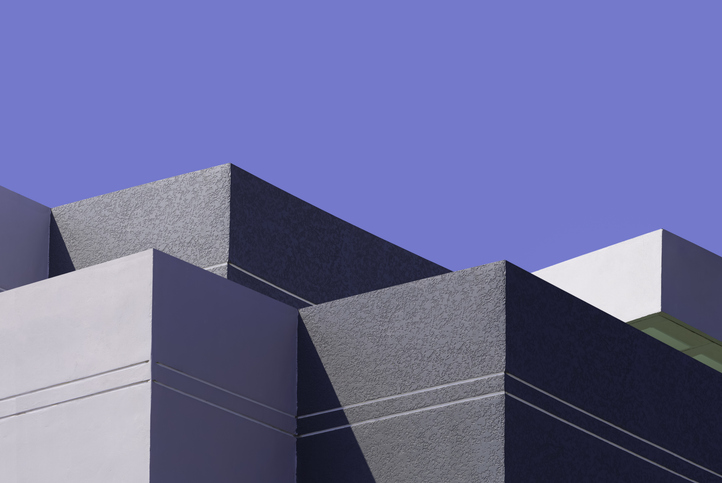 High section of gray and white buildings group in geometric shape with sunlight and shadow on surface against blue clear sky background, Exterior architecture in minimal style