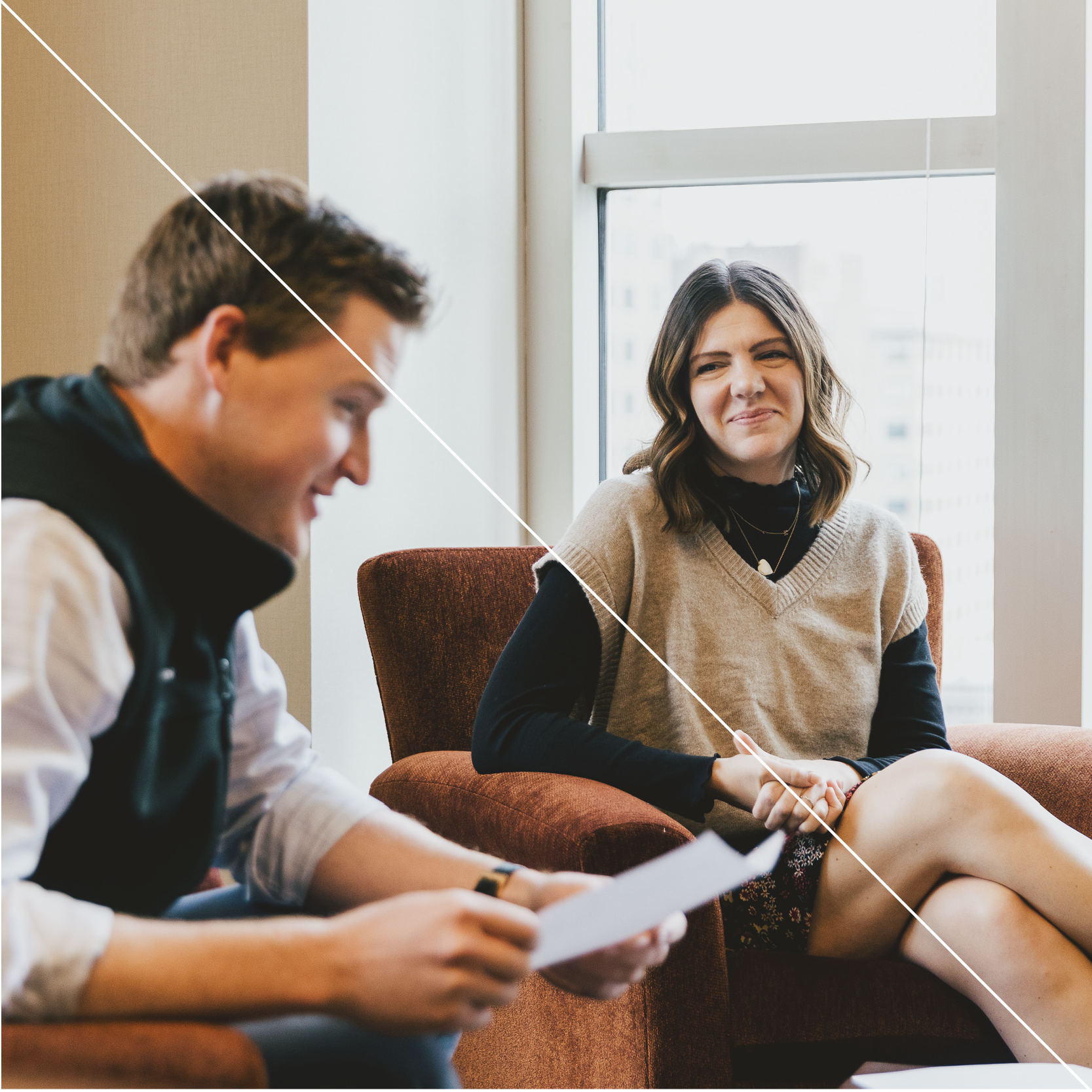 Young man and woman talking in office