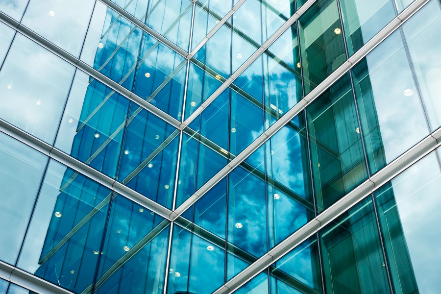 Glass windows with blue sky reflecting