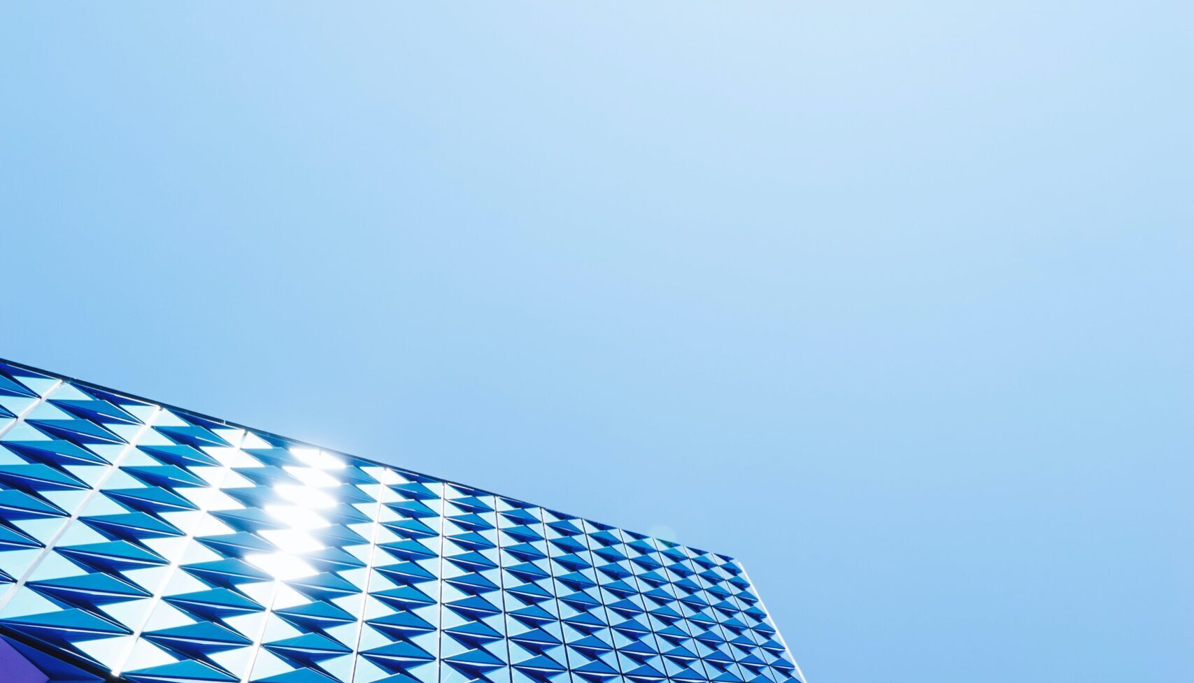 Geometric windows against a blue sky